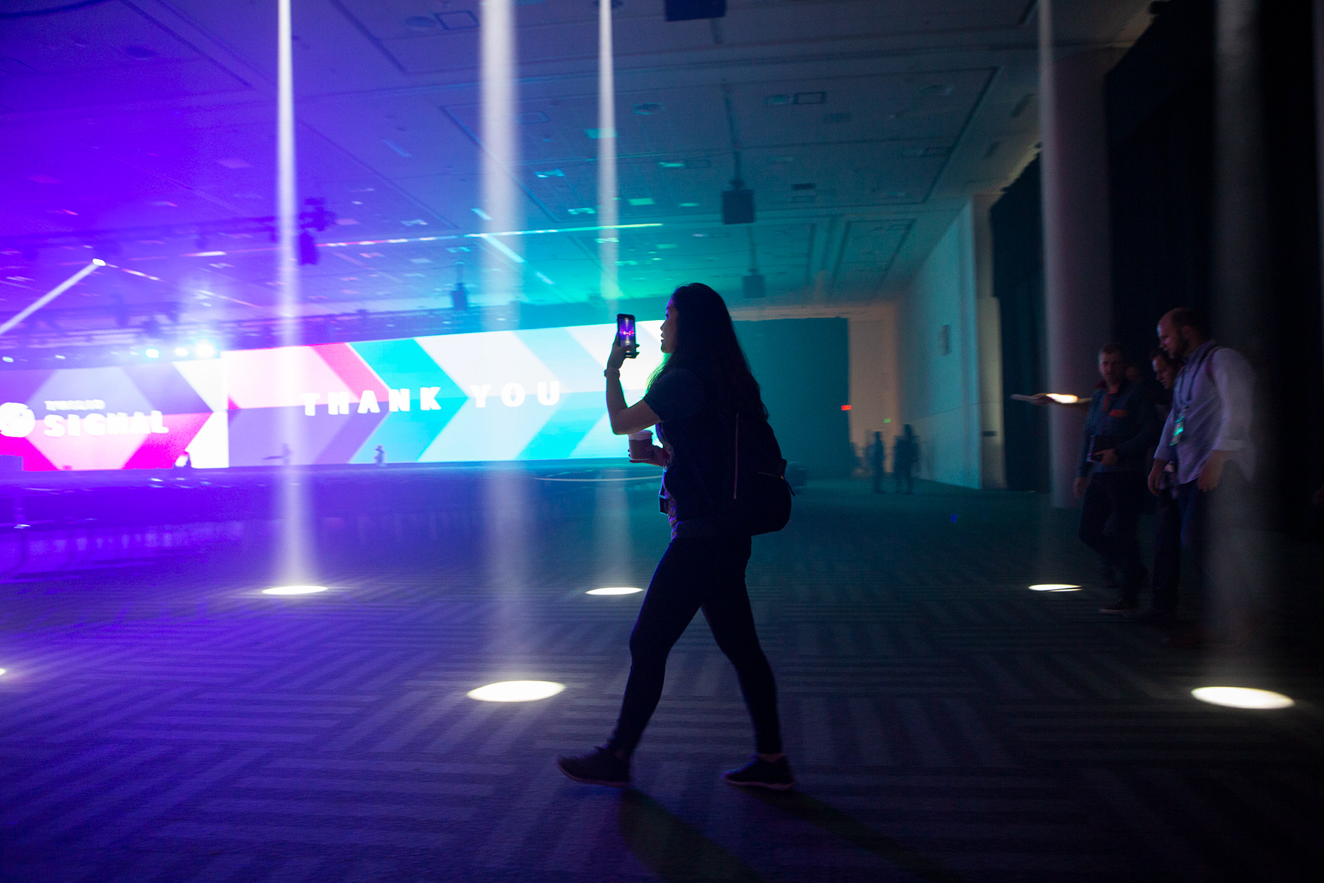Attendee silhouetted against Twilio Signal Thank You closing screen with dramatic light beams